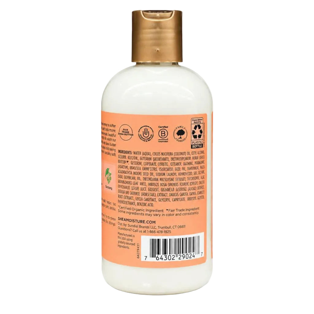 Back view of a Shea Moisture bottle with a gold cap and an orange label showing ingredients and a barcode on a white background.