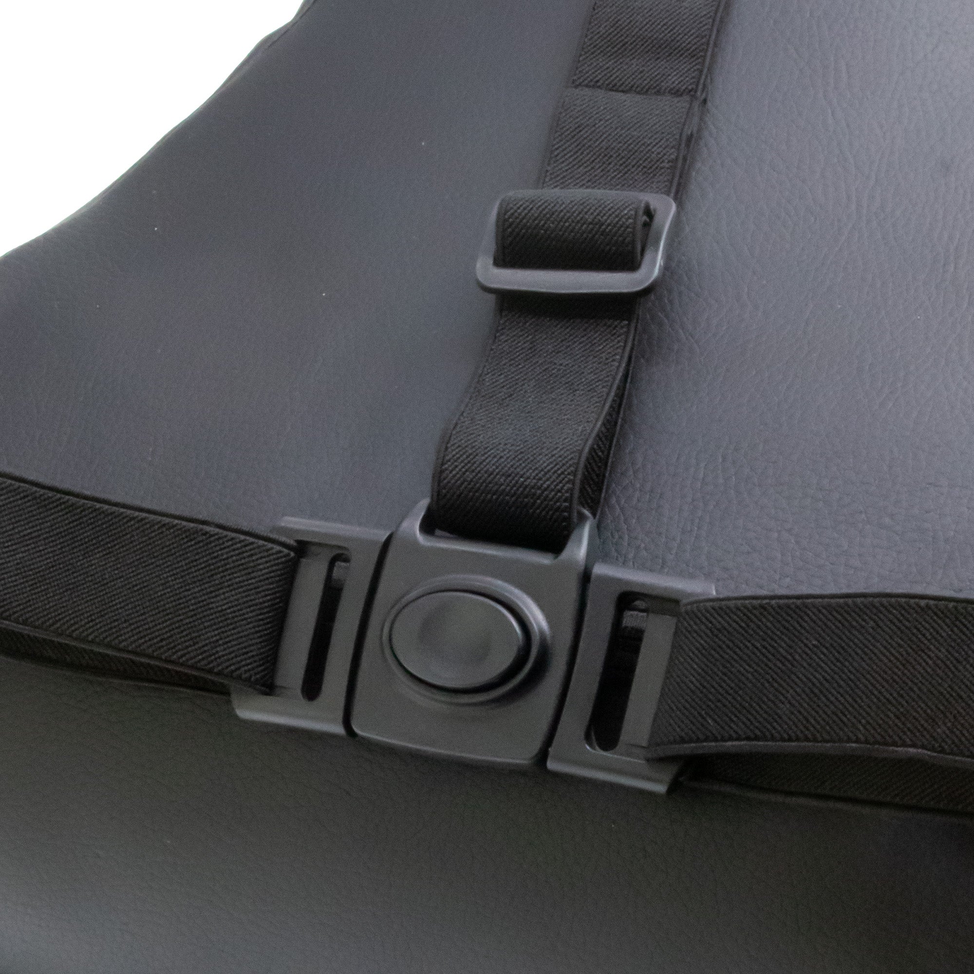 Close-up of a black seat belt buckle on a gray car seat.